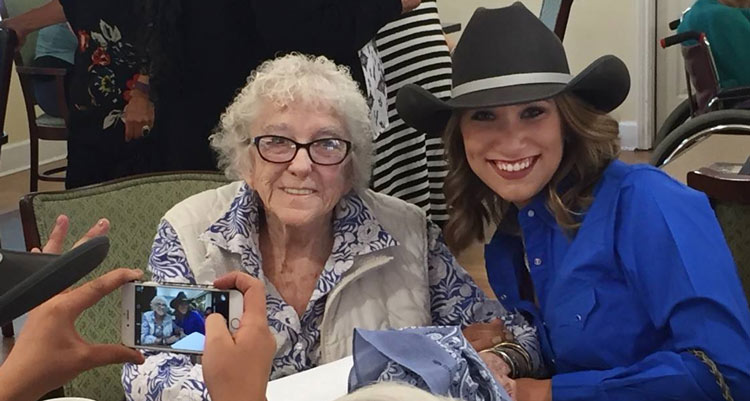 Elderly woman smiling with her granddaughter at Juniper House Assisted Living & Memory Care